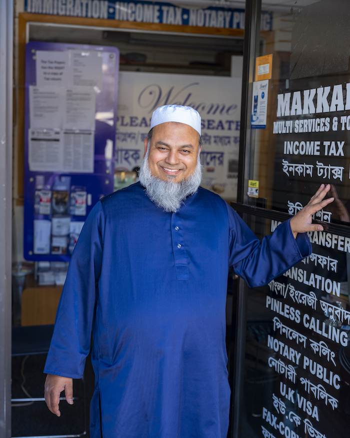 Portrait of Kobir Chowdhury outside Makkah Multi Services and Tour