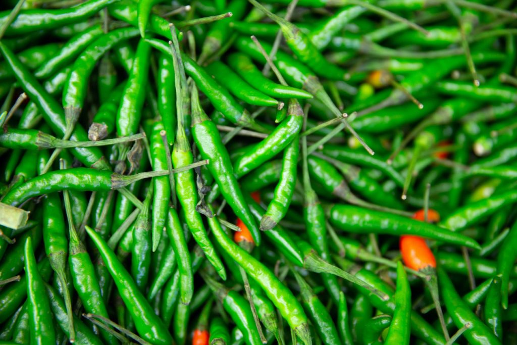 Close-up shot of green chili peppers.